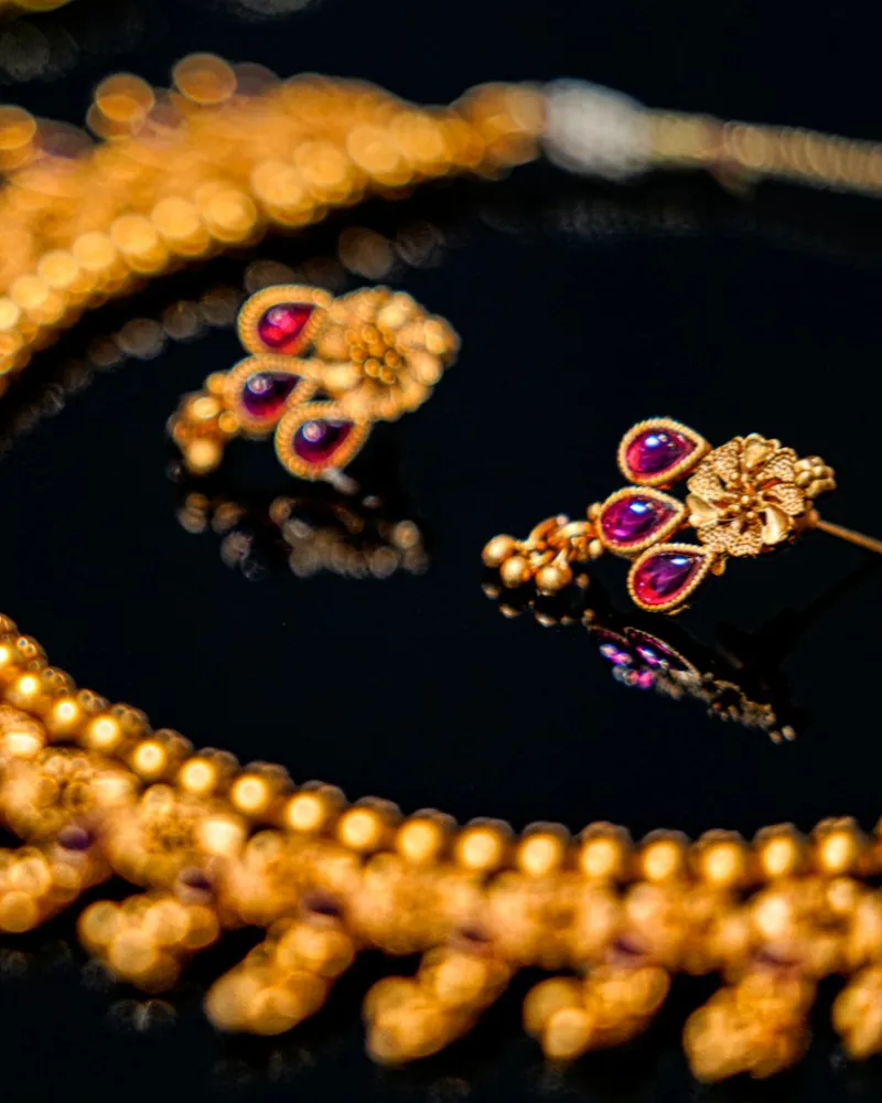 Gold temple necklace with ruby-set earrings